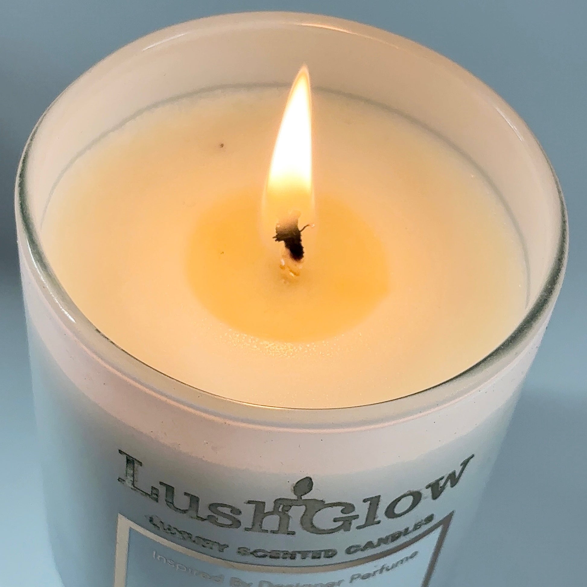 Luxury white soy candle burning softly – floral aroma for romantic ambiance